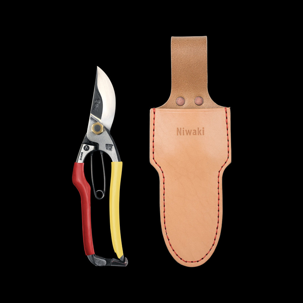 Gardening shears with a leather sheath on a black background, featuring the brand 'Niwaki'.